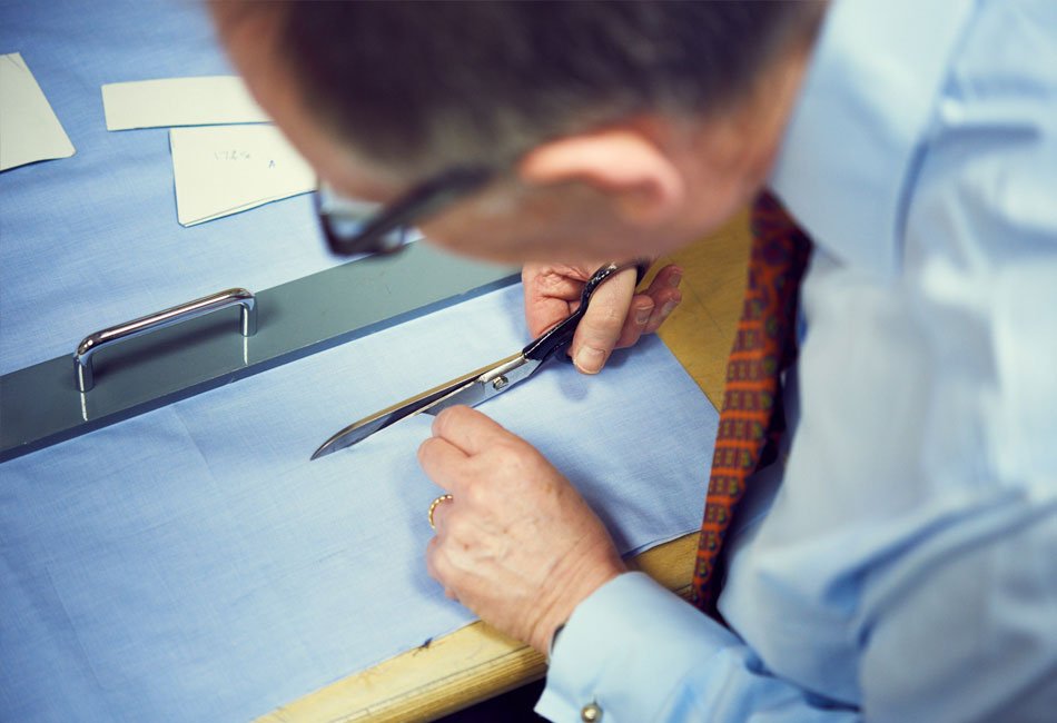 Stephen Lachter cutting the shirt fabric