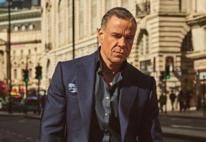Scott walking down the streets of London with his Kent & Haste suit
